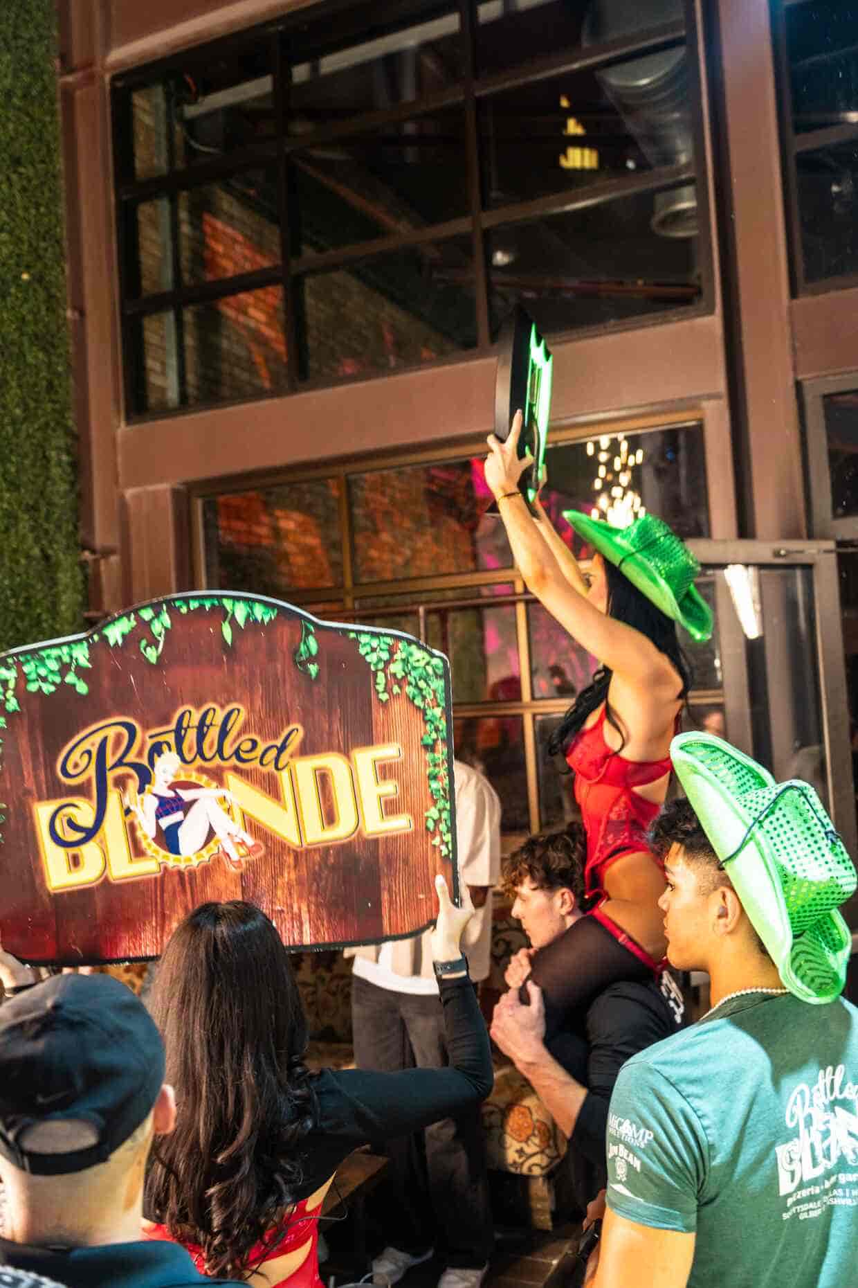 Bottle service at Bottled Blonde Scottsdale turns up the energy with dancers in themed outfits, custom signs, and a vibrant crowd in the heart of Old Town. A must-see nightlife experience in Arizona.